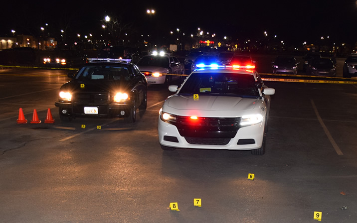 Photo of patrol cars at a crime scene.